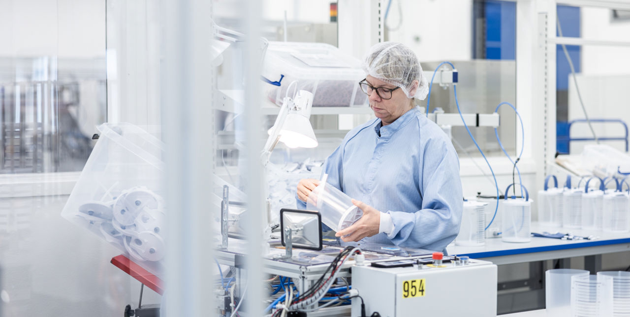 Person testing product in a cleanroom.