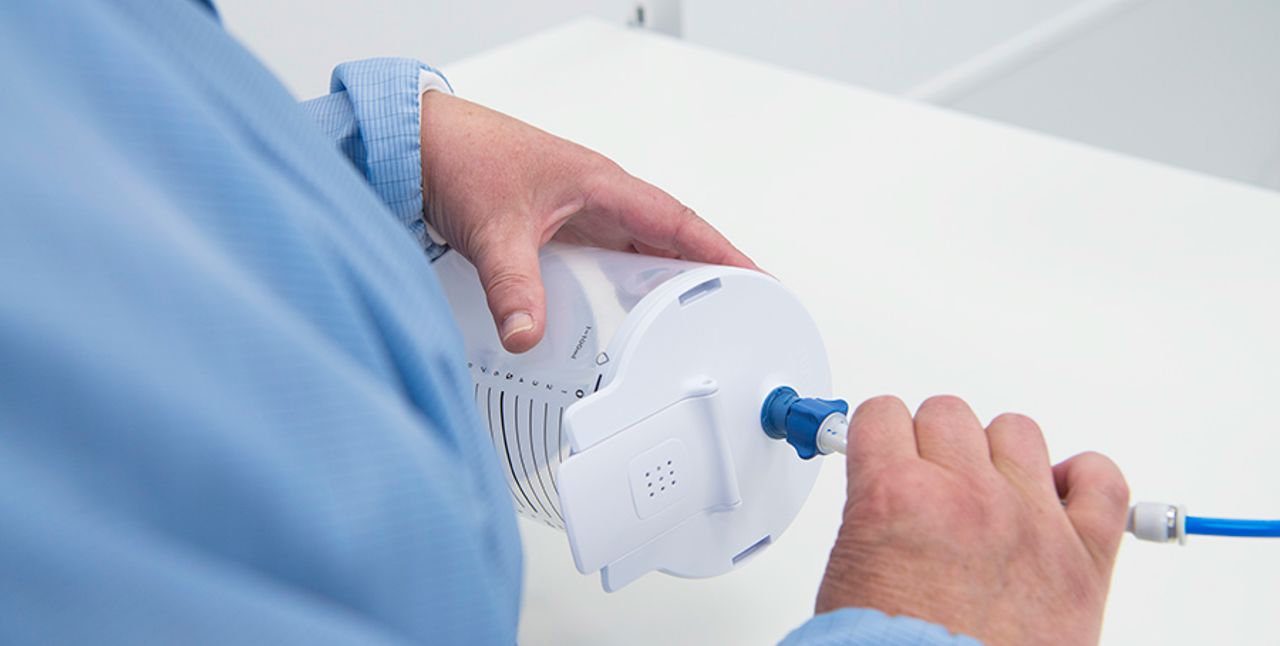 Closeup of hands assembling a product.